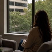 Person reflecting quietly by a window before beginning EMDR therapy in Huntsville.
